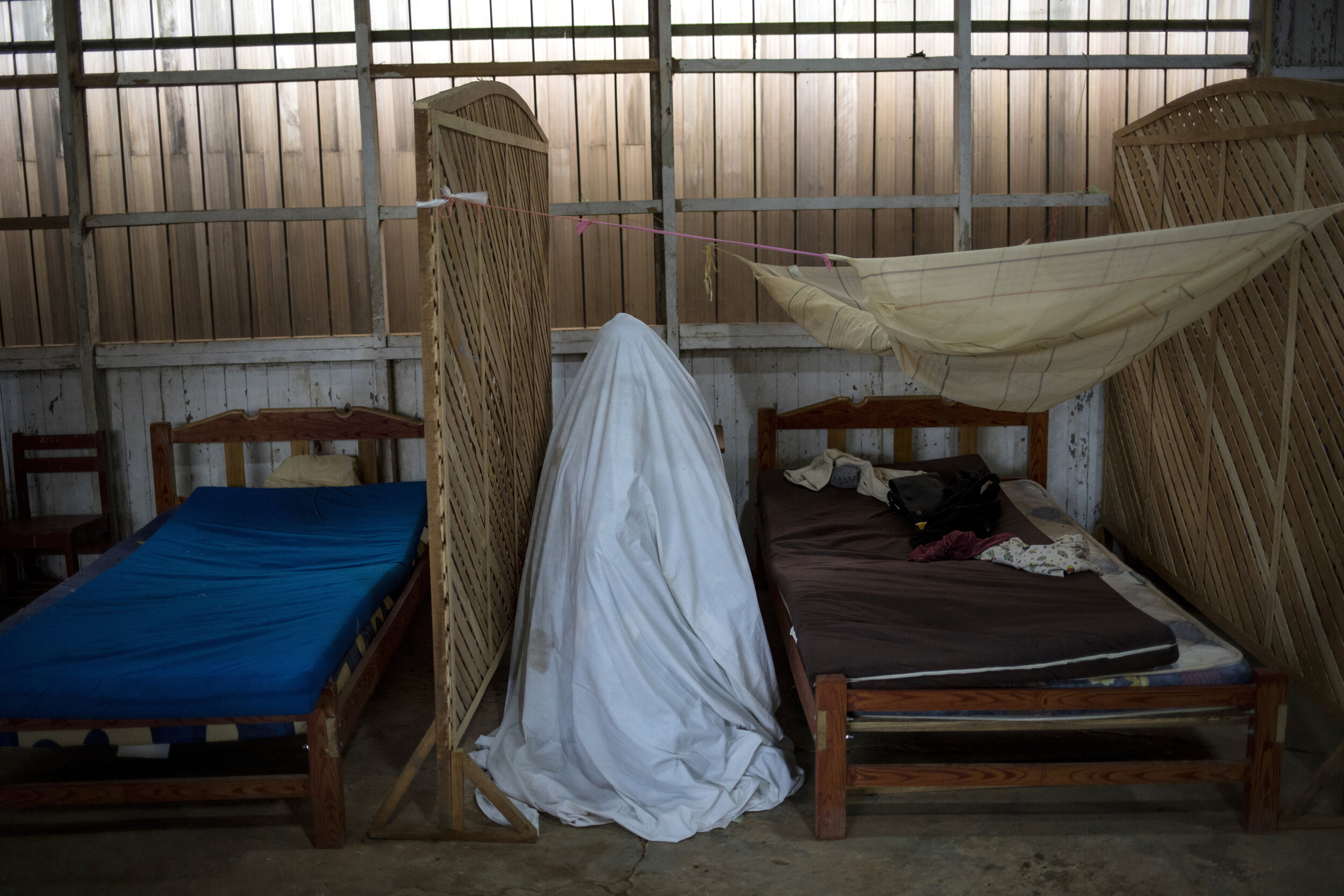  Sara Magin, who suffers from COVID-19 symptoms, sits inside a tent constructed from a bedsheet as she receives an herbal vapor therapy in the Shipibo Indigenous community of Pucallpa in Peru's Ucayali region, Tuesday, Sept. 1, 2020. (AP Photo/Rodrig