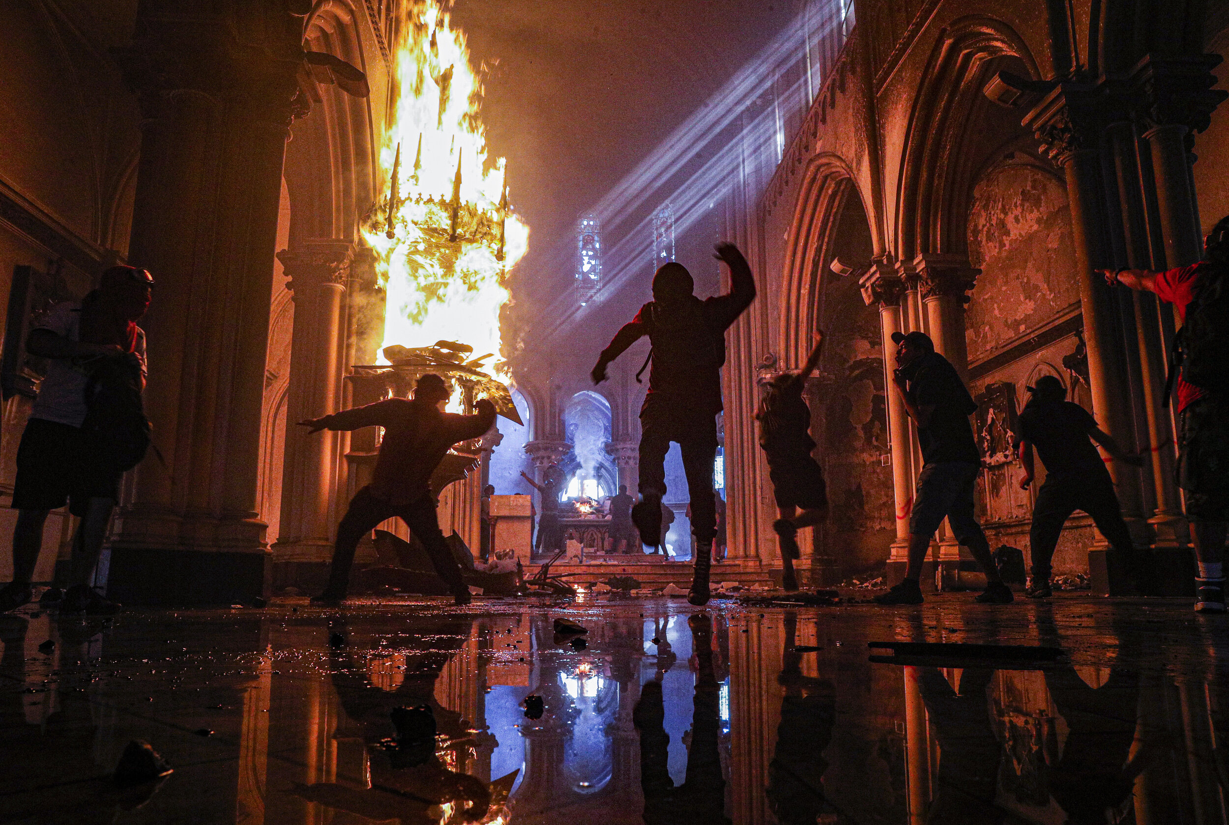  Protesters storm the San Francisco de Borja church that belongs to Carabineros, Chile's national police force, on the one-year anniversary of the start of anti-government protests against inequality in Santiago, Chile, Sunday, Oct. 18, 2020. (AP Pho