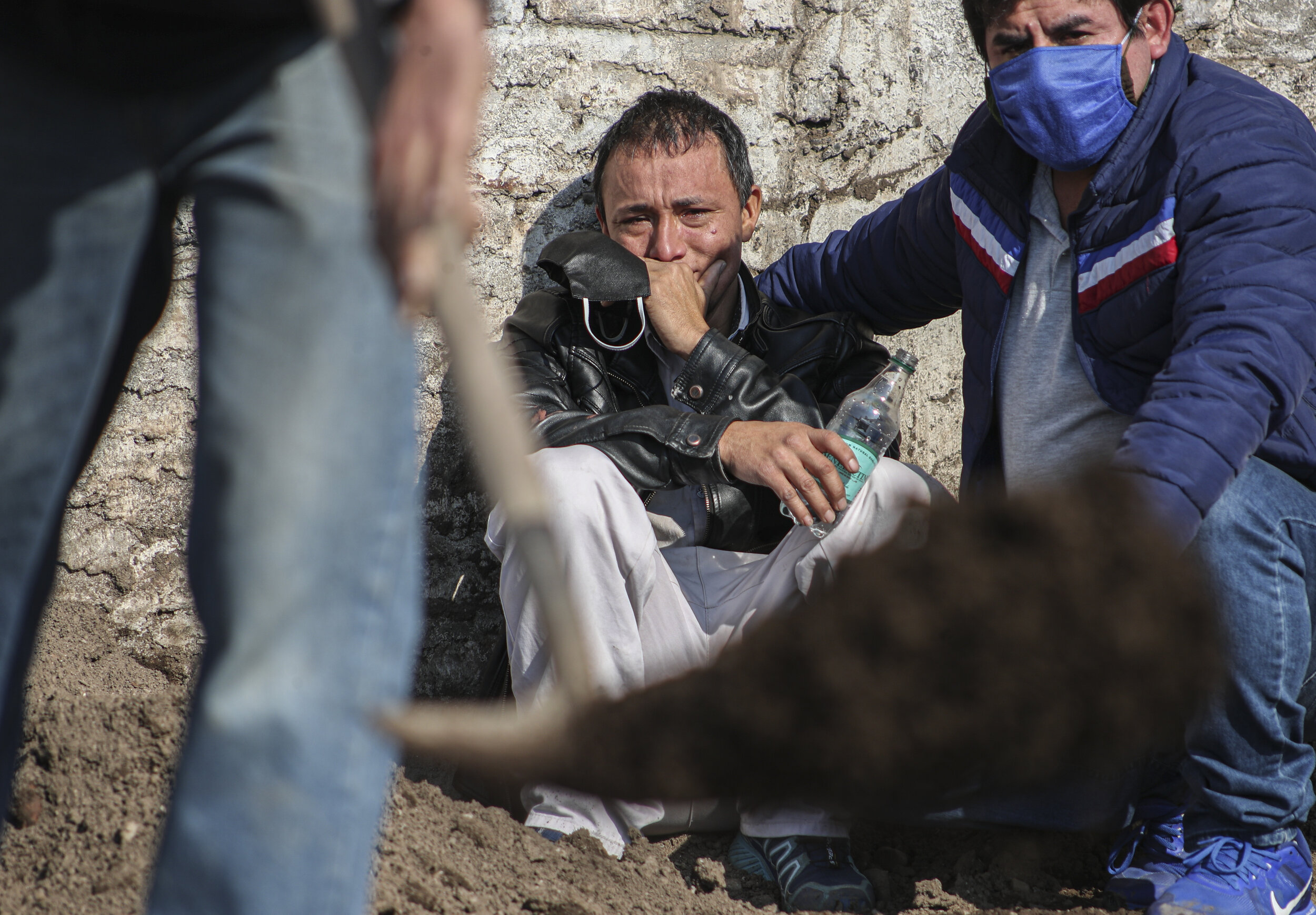  Peruvian migrant Jose Collantes cries as he watches cemetery workers bury his wife Silvia Cano, who he said died of COVID-19 complications, at the Catholic Cemetery in Santiago, Chile, Friday, July 3, 2020. Collantes said he preferred to cremate her