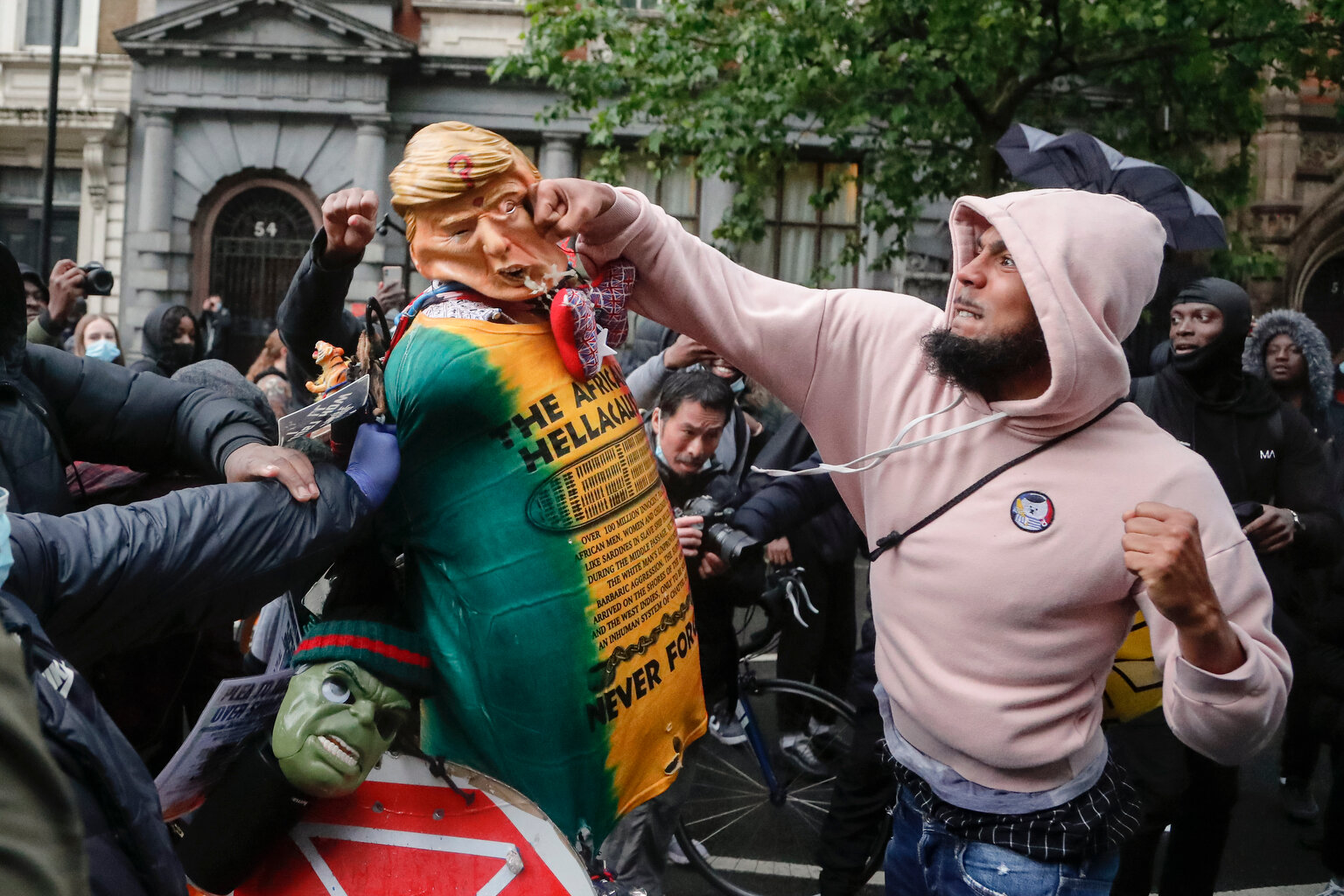  A demonstrator punches a puppet depicting US President Donald Trump during a Black Lives Matter march in London, Saturday, June 6, 2020, as people protest against the killing of George Floyd by police officers in Minneapolis, USA. Floyd, a black man