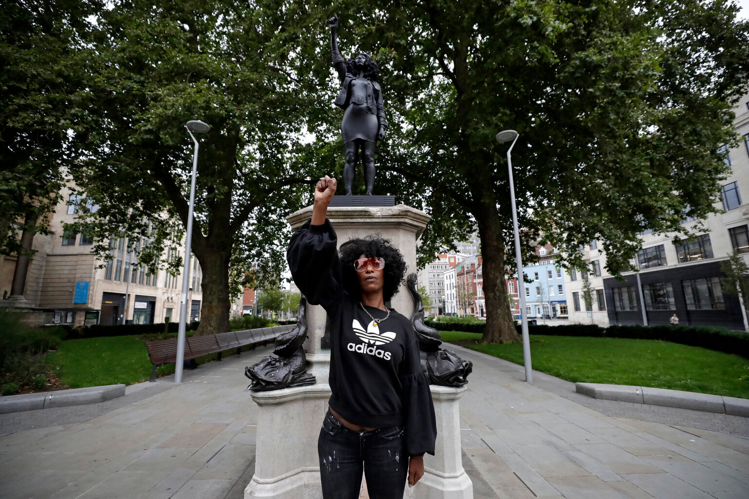  Jen Reid poses for photographs in front of the new black resin and steel statue portraying her, entitled "A Surge of Power (Jen Reid) 2020" by artist Marc Quinn after the statue was put up this morning on the empty plinth of the toppled statue of 17