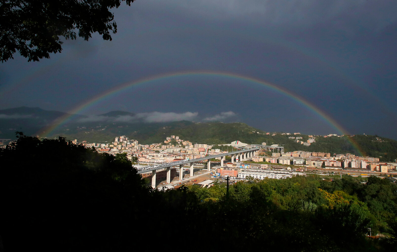  A rainbow shines over the new San Giorgio Bridge in Genoa, Italy, Monday, Aug. 3, 2020. A large section of the old Morandi bridge collapsed on Aug. 14, 2018, killing 43 people and forcing the evacuation of nearby residents from the densely built-up 