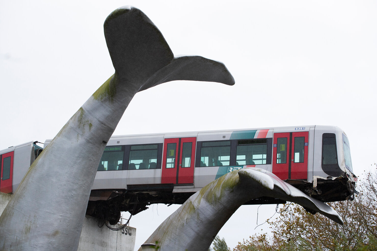  A whale tail sculpture holds the front carriage of a metro train as it rammed through the end of an elevated section of tracks in Spijkenisse, near Rotterdam, Netherlands, on Monday, Nov. 2, 2020. (AP Photo/Peter Dejong) 
