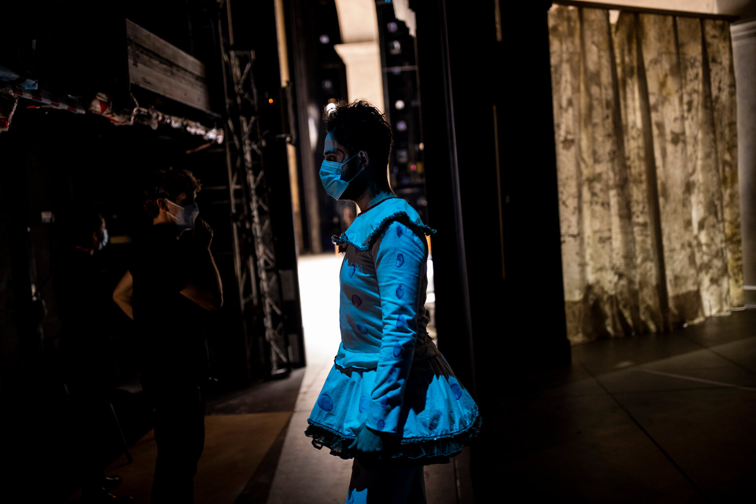  An opera cast member, wearing a mask to prevent the spread of coronavirus, waits behind the stage during the performance of Rusalka in Teatro Real, Madrid, Spain Thursday, Nov. 12, 2020. (AP Photo/Bernat Armangue) 
