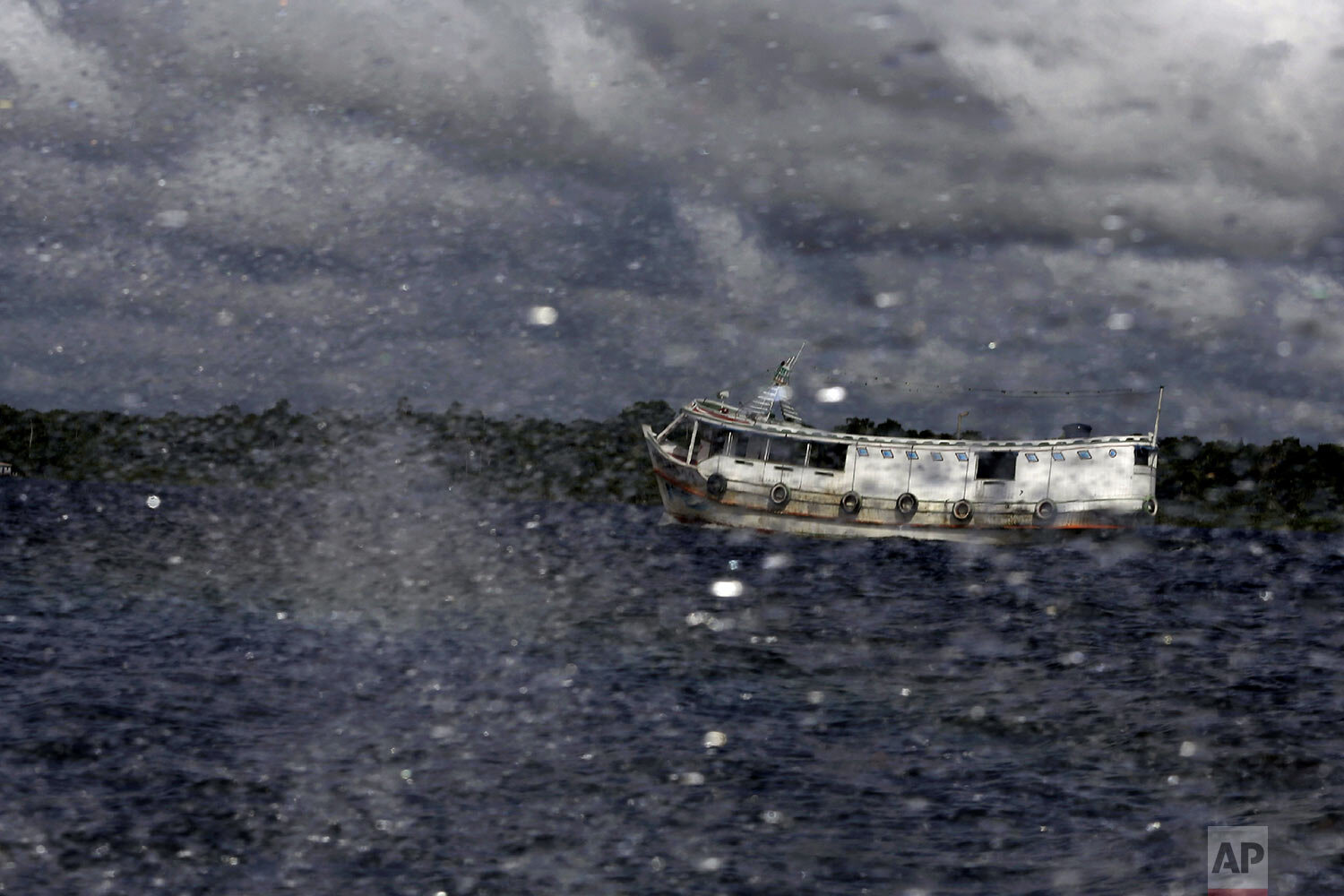 A traditional Amazon boat navigates the Tauau River near the city of Portel on Marajo island in Para state, Brazil, Friday, Dec. 4, 2020. (AP Photo/Eraldo Peres)