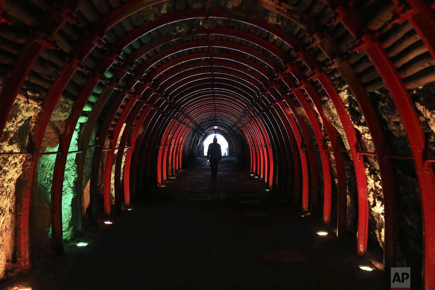 A man exits after touring the underground, New Salt Cathedral in Zipaquira, Colombia, Wednesday, Dec. 16, 2020. Considered the First Wonder of Colombia, the architectural, religious, and salt mining site marked its first 25 years of history in 2020. (AP Photo/Fernando Vergara)