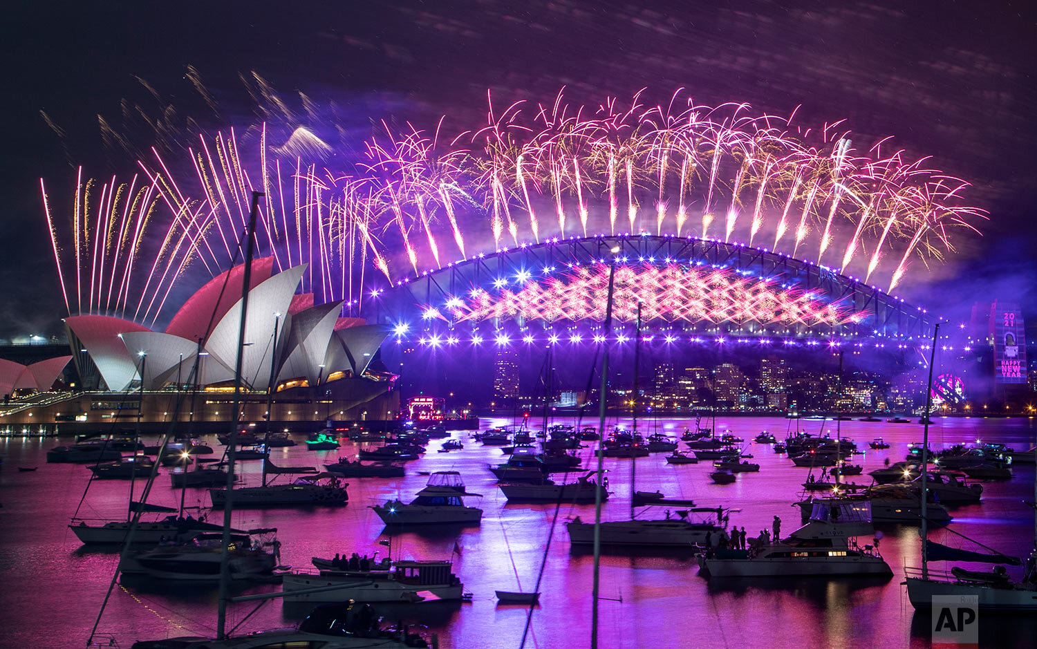  Fireworks explode over the Sydney Opera House and Harbour Bridge as New Year celebrations begin in Sydney, Australia, Thursday, Dec. 31, 2020. (AP Photo/Mark Baker) 