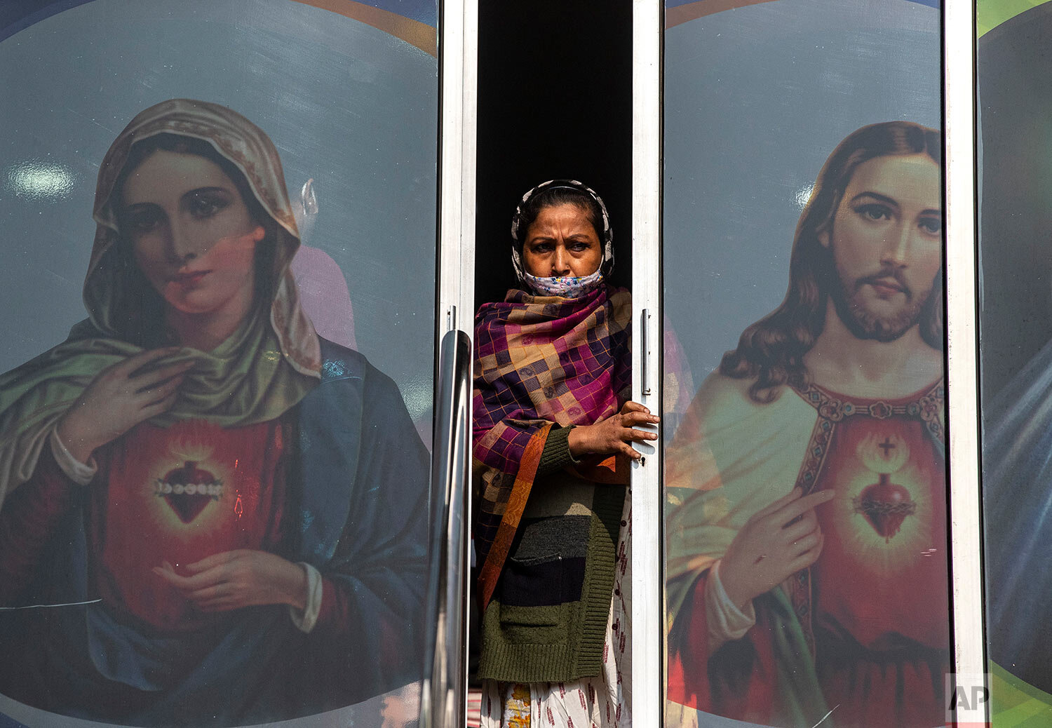  A Christian woman, partially wearing a face mask as a precaution against the coronavirus, leaves after attending a Christmas mass at a church in Gauhati, India, Friday, Dec. 25, 2020. (AP Photo/Anupam Nath) 