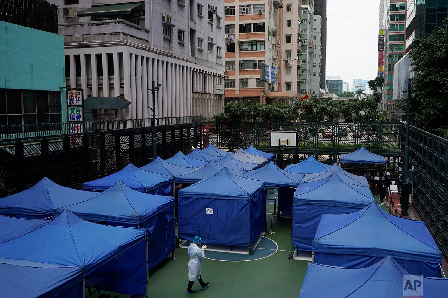  A medical worker in a protective suit walks at a coronavirus testing center in Hong Kong, Tuesday, Dec. 8, 2020. (AP Photo/Kin Cheung) 