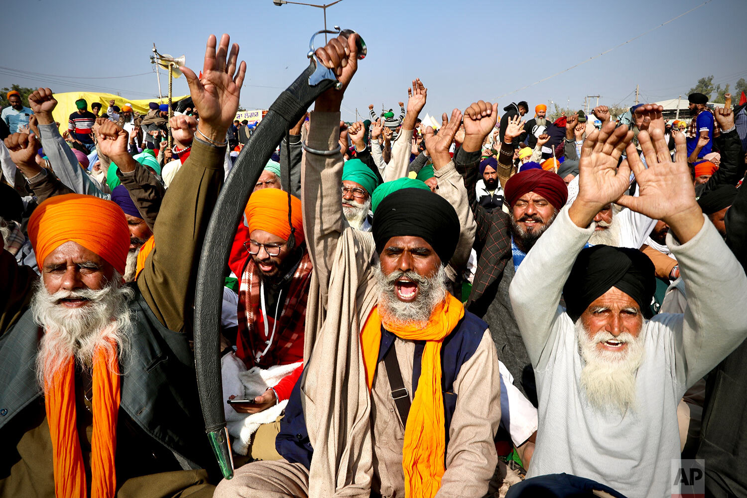  Protesting farmer leaders shout slogans as they sit on a day long hunger strike at the Delhi- Haryana border, outskirts of New Delhi, Monday, Dec. 14, 2020.  (AP Photo/Manish Swarup) 
