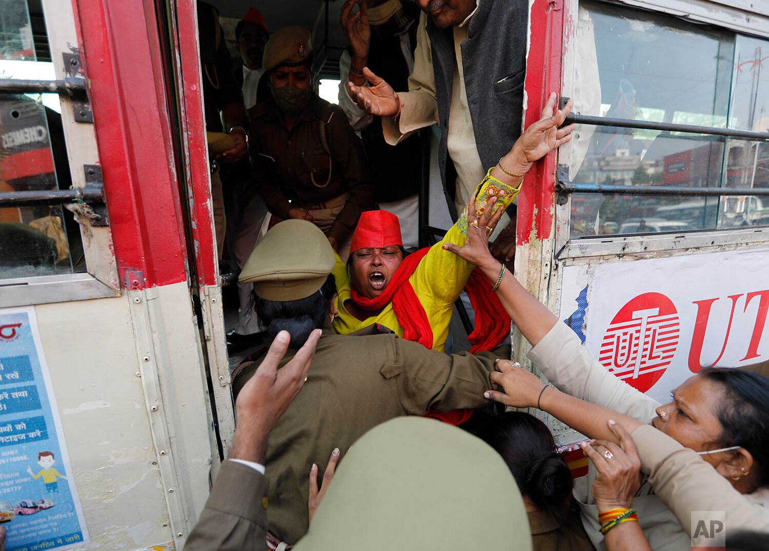  A Samajwadi Party supporter shouts slogans as she is detained by police for trying to enforce a nationwide farmers' strike  in Prayagraj, Tuesday, Dec. 8, 2020. (AP Photo/Rajesh Kumar Singh) 