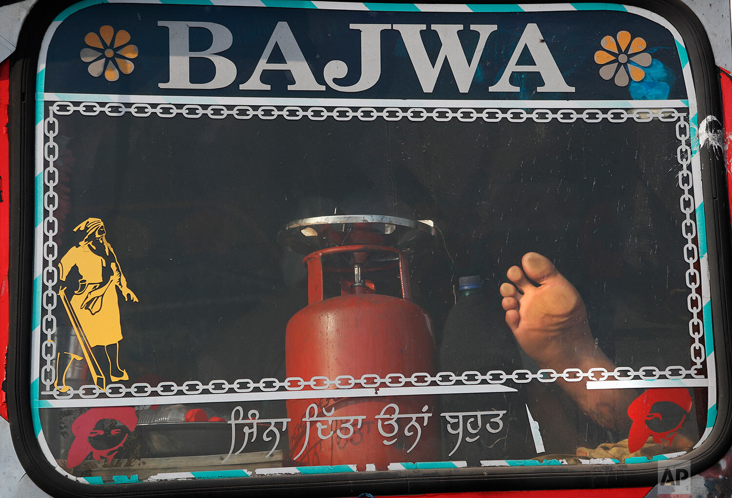  An Indian farmer rests inside his truck at the site of a protest on a highway at the Delhi-Haryana state border, India, Thursday, Dec. 3, 2020. (AP Photo/Manish Swarup) 