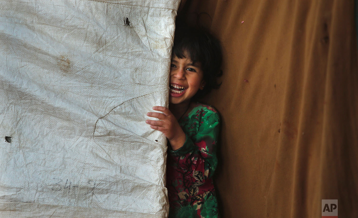  A nomadic Gujjargirl looks out from her temporary shelter on the outskirts of Jammu, India, Thursday, Dec. 3, 2020. (AP Photo/Channi Anand) 