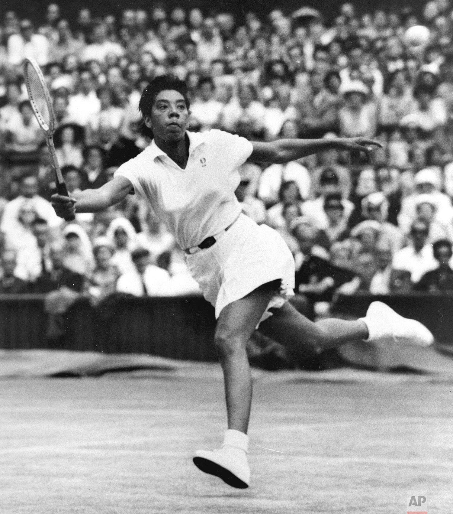  Althea Gibson prepares to volley against Britain's Ann Haydon during the Wimbledon womens singles semifinal tennis match in Wimbledon, England, in this July 3, 1958 file photo. (AP Photo) 