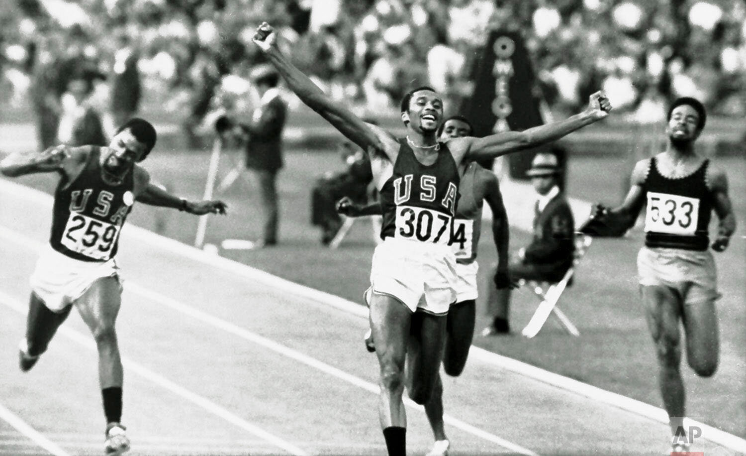  Tommie Smith of the U.S. raises his arms as he wins the 200 meters Olympic sprint in Mexico City Oct. 16, 1968.  Teammate John Carlos (259) finished third.  At far right is Michael Fray of Jamaica, who did not place.  Smith and Carlos caused controv