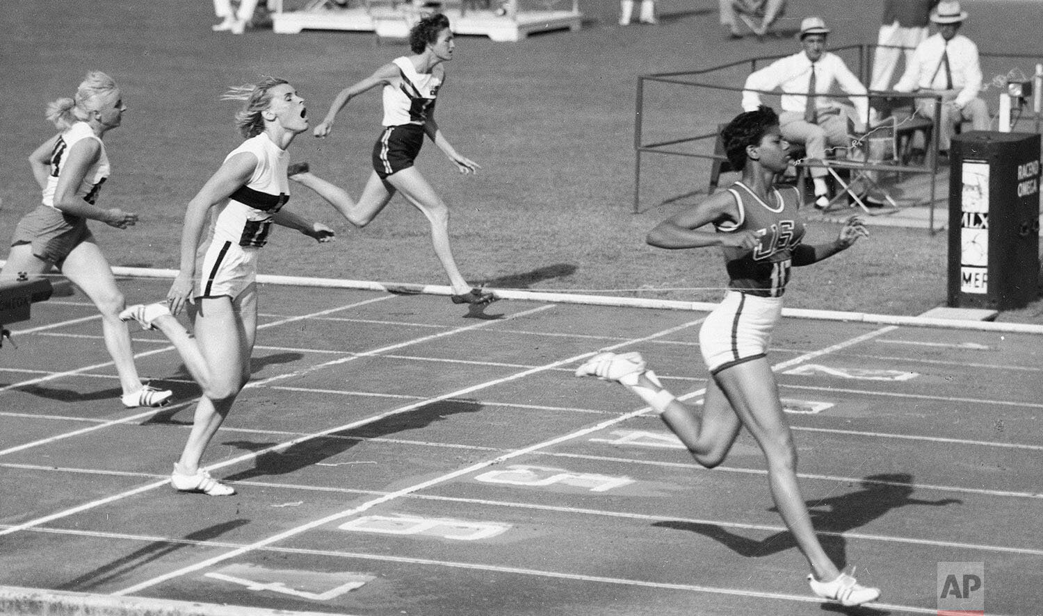  Wilma Rudolph of the United States, right, romps home to win her semi-final of the women's 200-meter race at the Olympic Games in Rome, Sept. 5, 1960. She is followed by Jutta Heine of Germany (black stripe on white shirt) who was second and Poland'