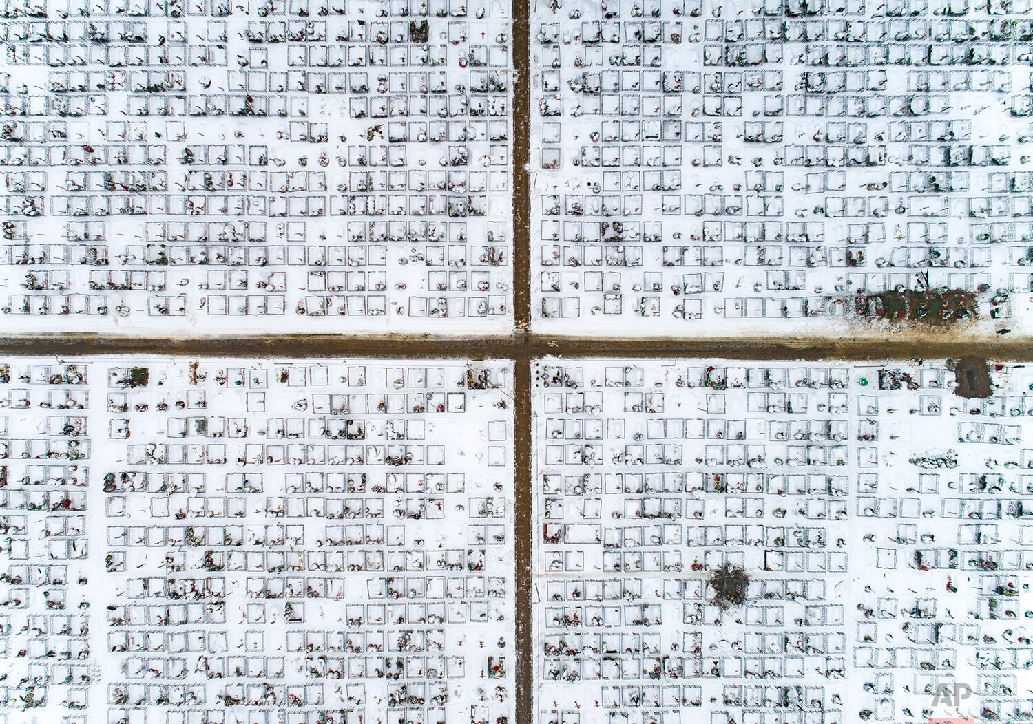  Freshly dug graves powdered with snow are seen at the Butovskoye cemetery, which serves as one of the burial grounds for those who died of the coronavirus, in Moscow, Russia, Thursday, Dec. 31, 2020. (AP Photo/Dmitry Serebryakov) 