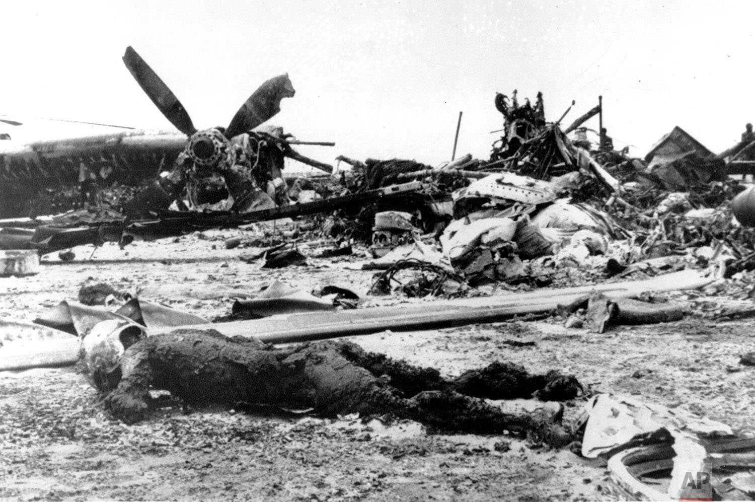  A charred body lies within the scorched wreckage of an American C-130 Cargo aircraft  in the Iranian desert of Dasht-E-Kavir, approximately 500 kilometers from Tehran, on April 27, 1980. The mission to free 50 American hostages from the U.S. Embassy