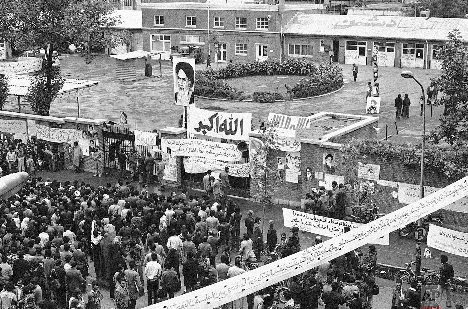  Iranian people gather before the entrance of the United States Embassy compound in Tehran, Iran  Nov. 6, 1979, on the third day of the occupation of the building. Iranian students took over the Embassy on Sunday and are still holding the staff hosta