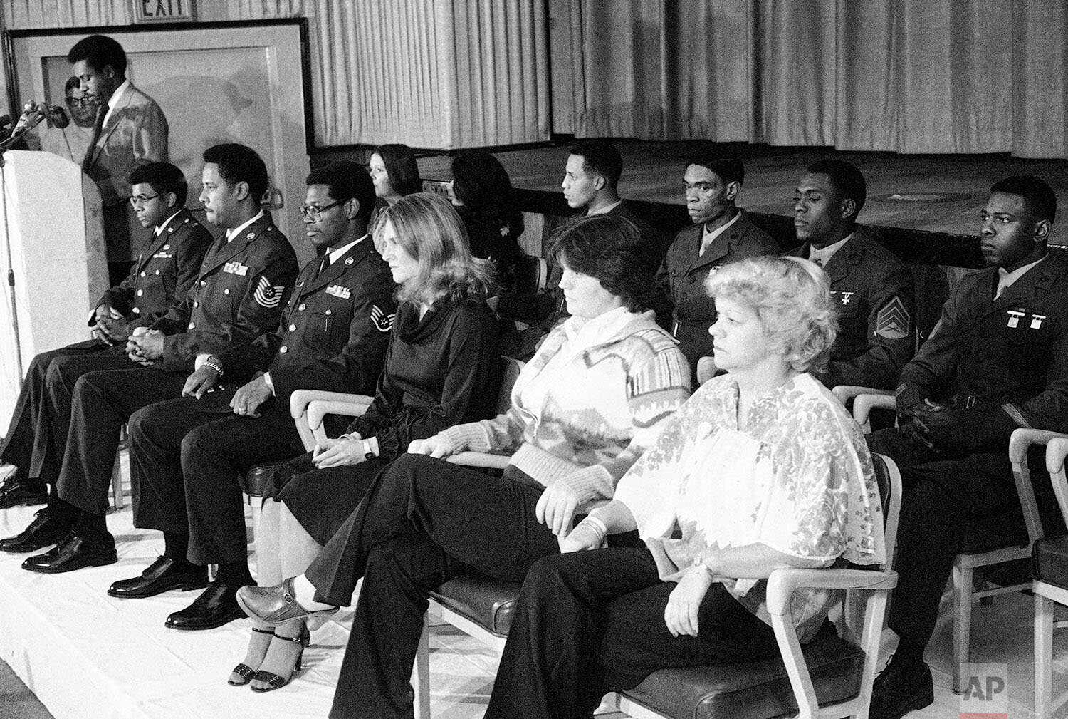  Thirteen American freed hostages from the U.S. embassy in Tehran on Nov. 21, 1979 seen in the theater of the local U.S. Air Force hospital at Wiesbaden, West Germany  appearing before journalists.   One of them, Lloyd Rollins (far left in rear of th