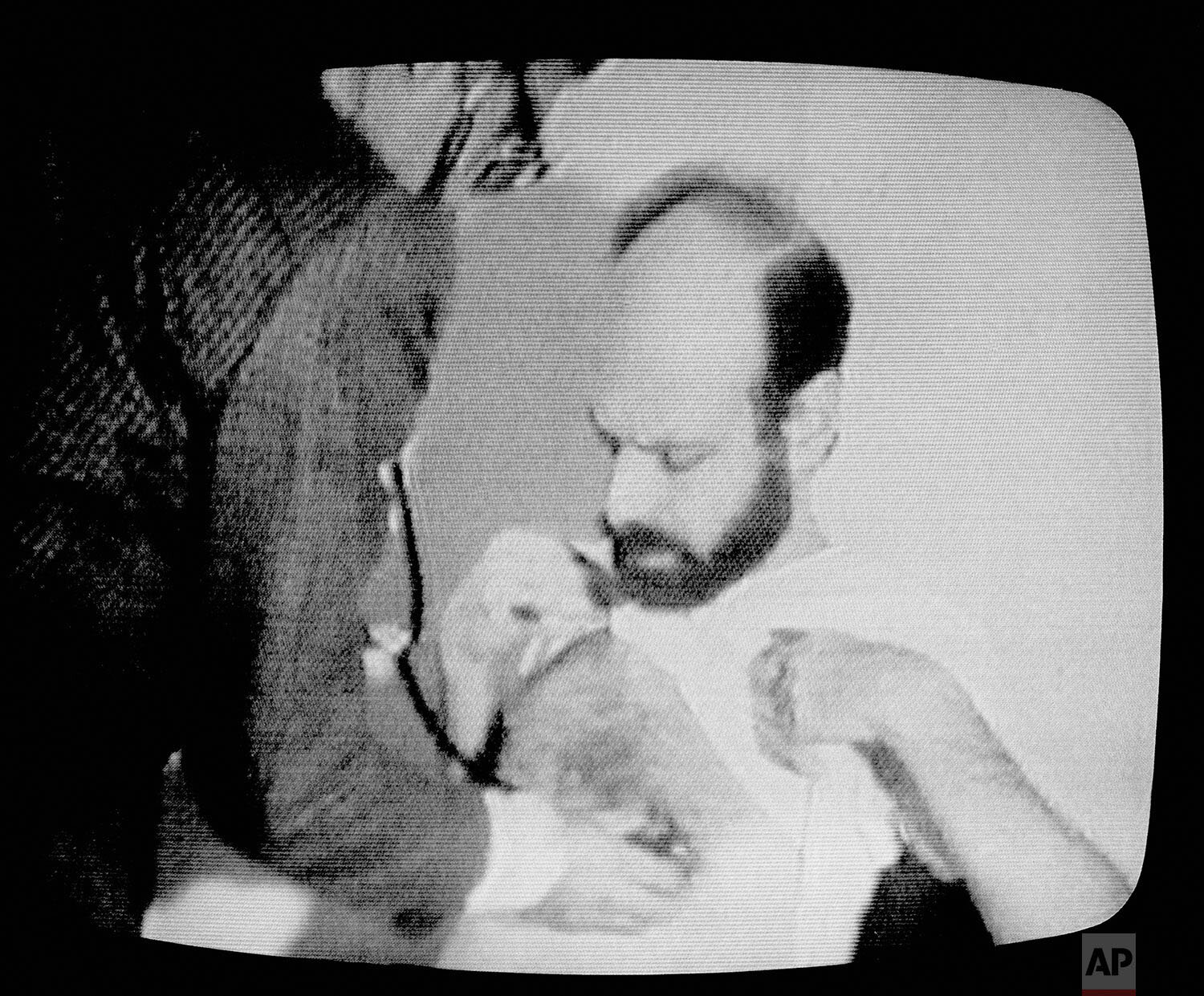  Barry Rosen, one of the American hostages being held in Iran, is shown on a video screen being treated by an Iranian Red Crescent doctor in the occupied U.S. Embassy in this film shot by the militants holding the hostages, March, 1980.  The video wa