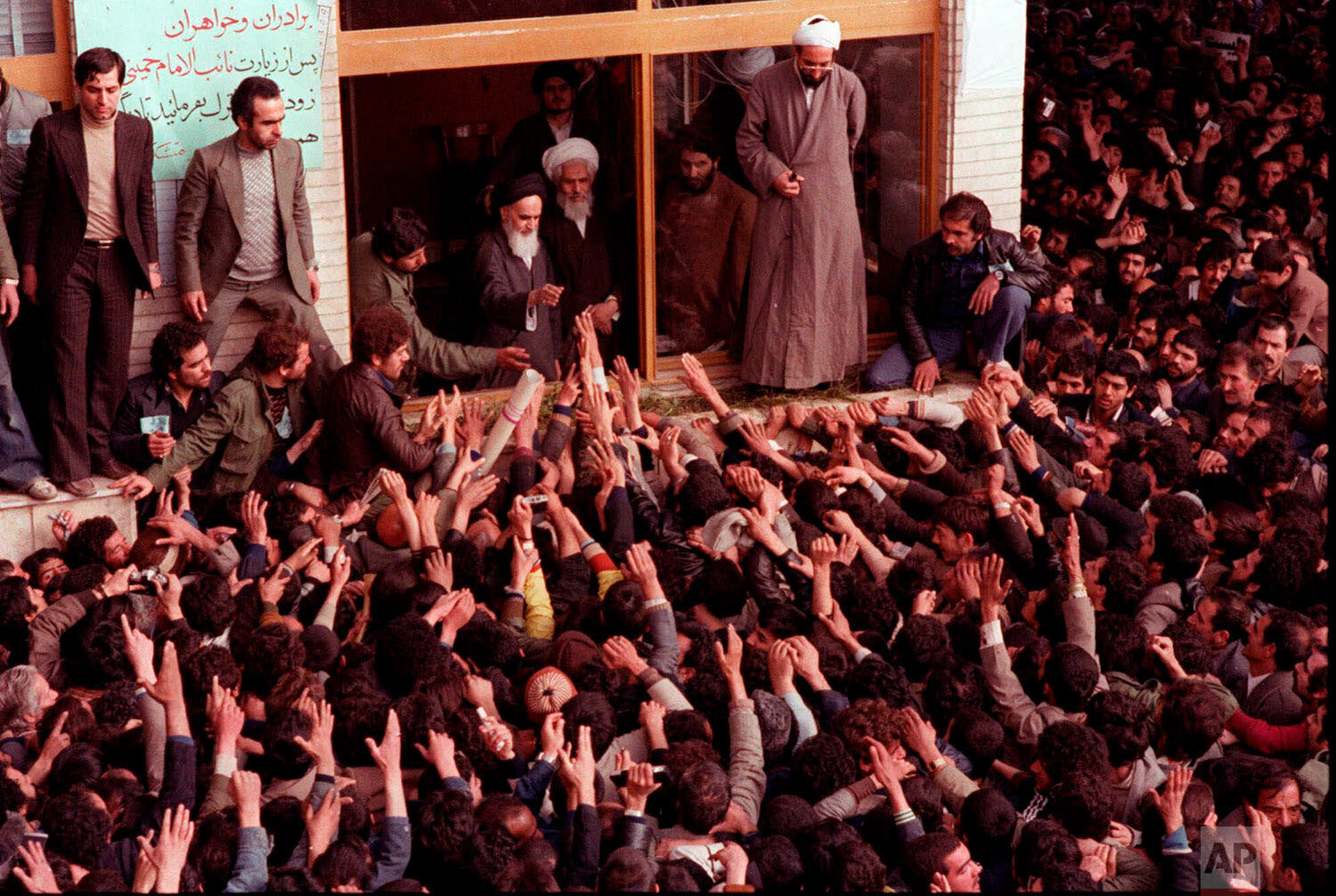   In this Feb. 2, 1979 photo, Ayatollah Ruhollah Khomeini, center, is greeted by supporters in Tehran, Iran.  (AP Photo) 