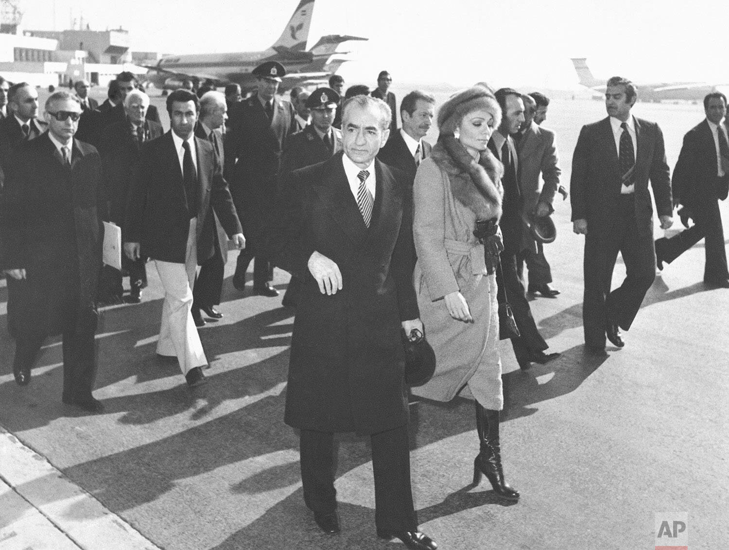  In this Jan. 16, 1979 photo, Shah Mohammad Reza Pahlavi and Empress Farah walk on the tarmac at Mehrabad Airport in Tehran, Iran, to board a plane to leave the country. Forty years ago, Iran's ruling shah left his nation for the last time and an Isl