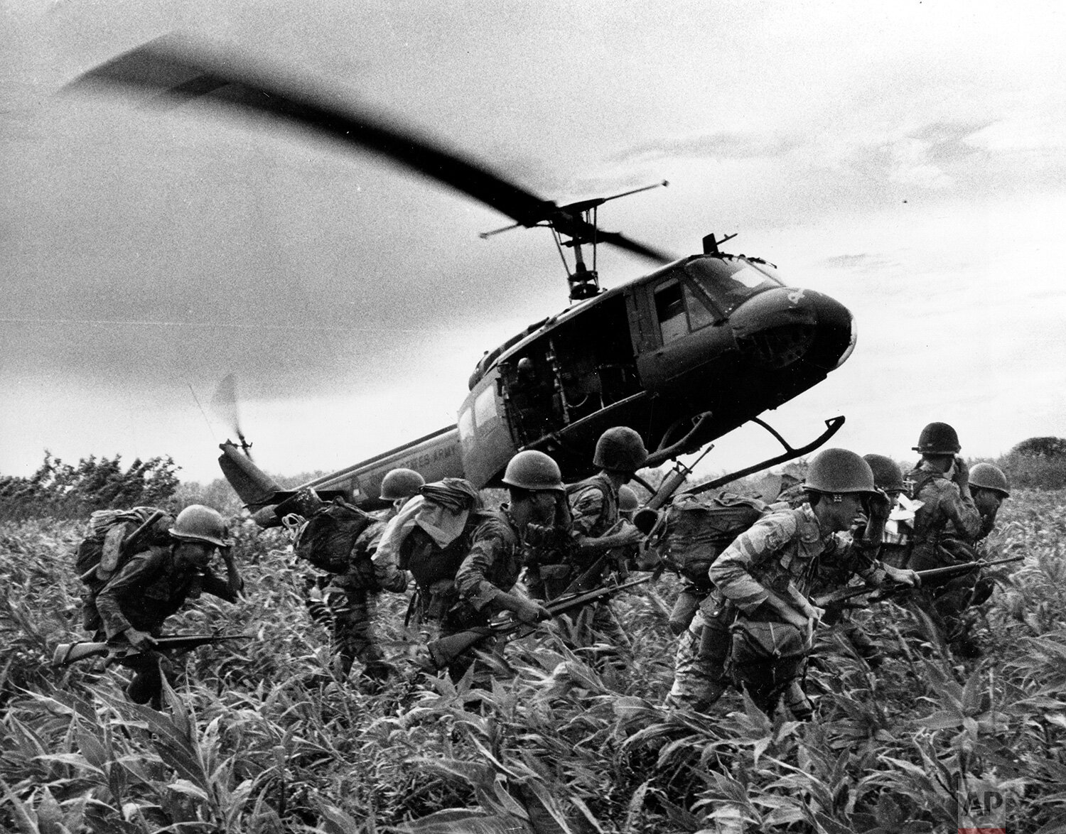  South Vietnamese Marines rush to point where descending U.S. Army helicopter will pick them up after a sweep east of the Cambodian town of Prey-Veng in June, 1970 during the Vietnam War.  The troops have been searching for a Viet Cong unit reported 