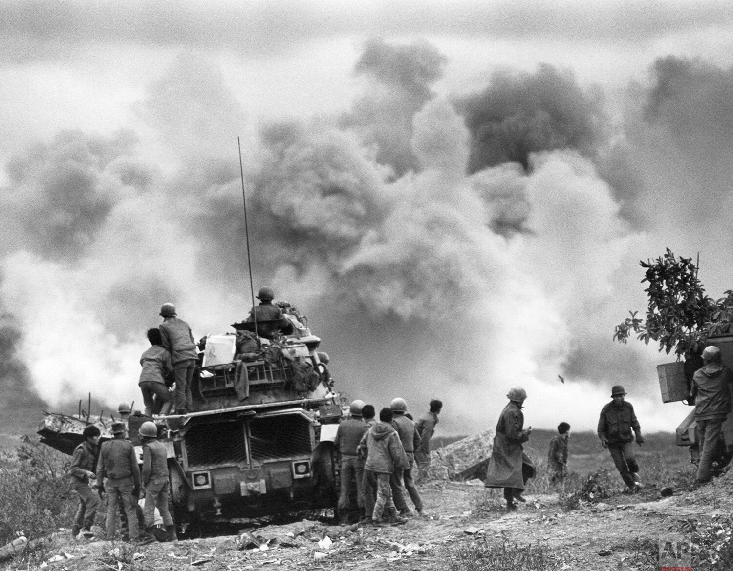  South Vietnamese troops eight miles West of Dong HA, South Vietnam, watch smoke billow skywards as B525 hit a North Vietnamese tank column attacking the position on April 11, 1972.  (AP Photo/Nick Ut ) 