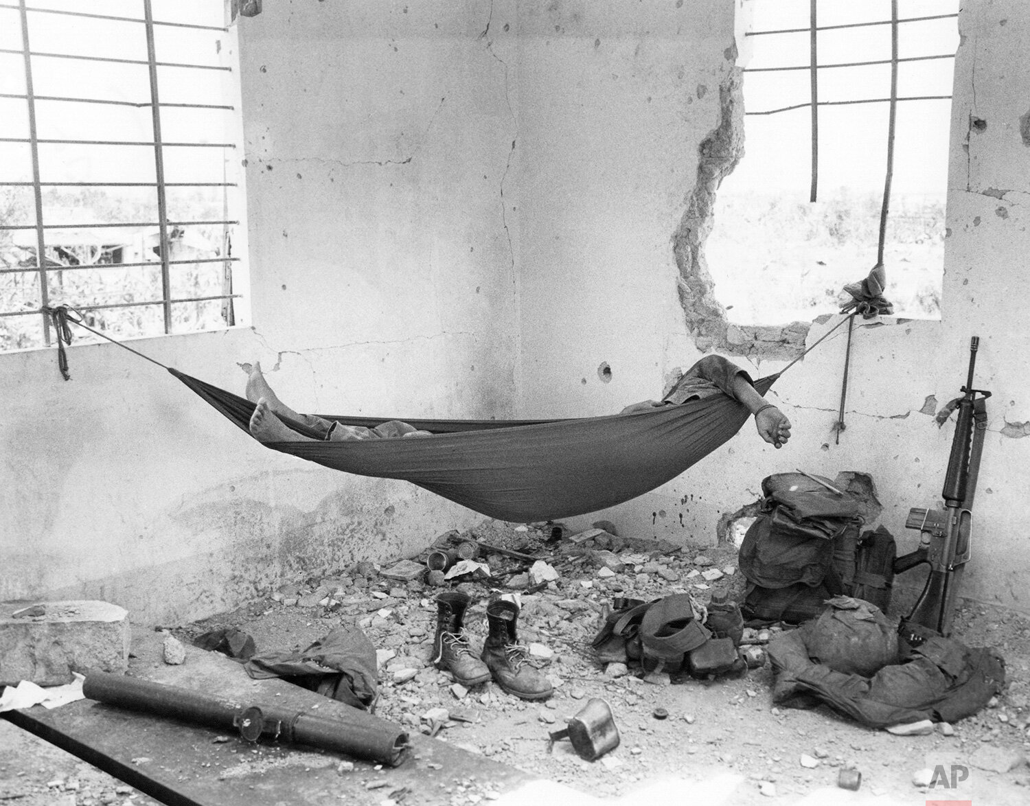  A South Vietnamese Marine naps in a hammock in an abandoned house in Quang Tri City, Vietnam, on Aug. 24, 1972, his weapons and equipment nearby. (AP Photo/Nick Ut) 