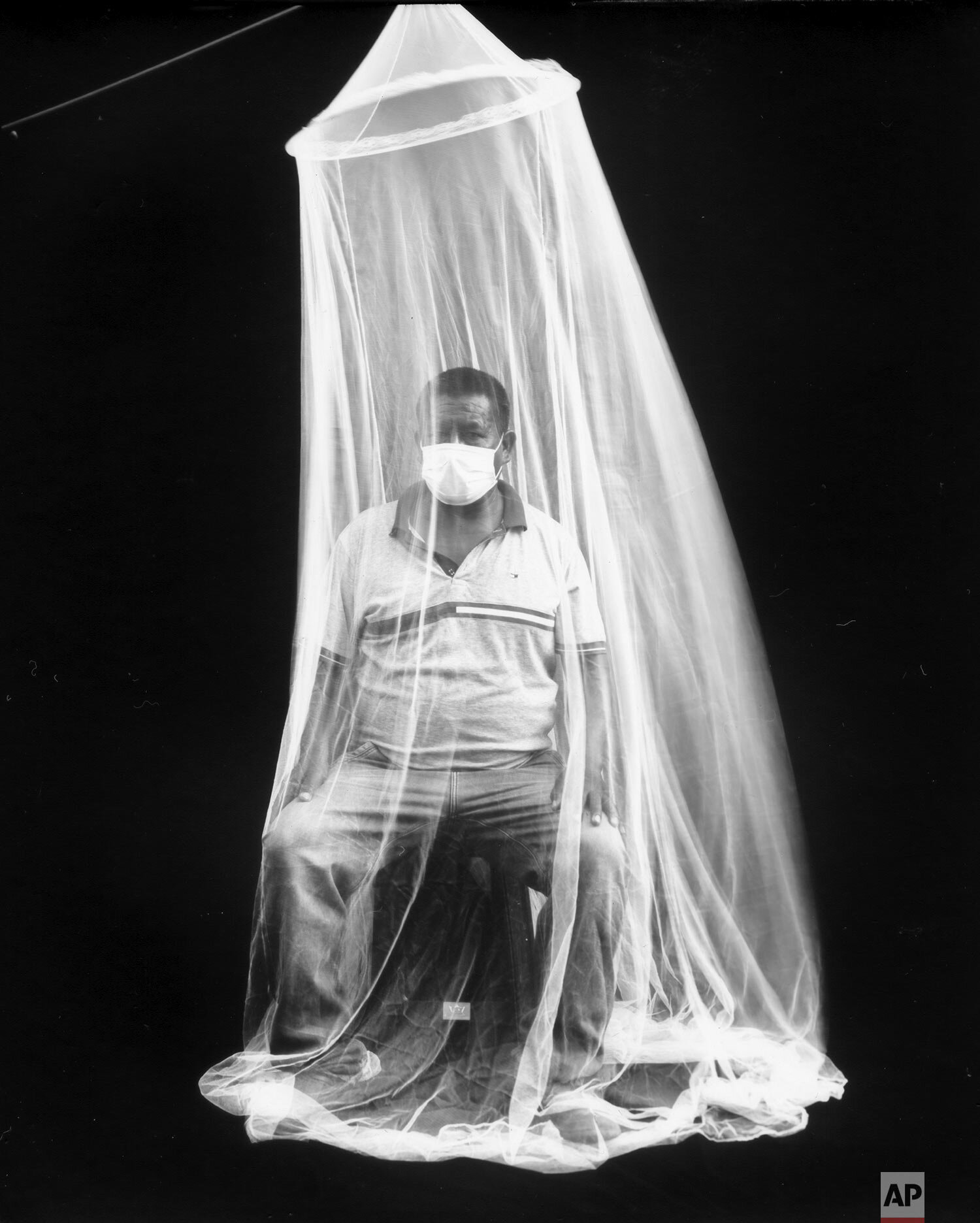  Vendor Daniel Torres Bazan poses for a portrait under one of his mosquito nets for sale at the Mesa Redonda Market in Lima, Peru, Oct. 20, 2020, published in Jan. 2021. (AP Photo/Rodrigo Abd) 