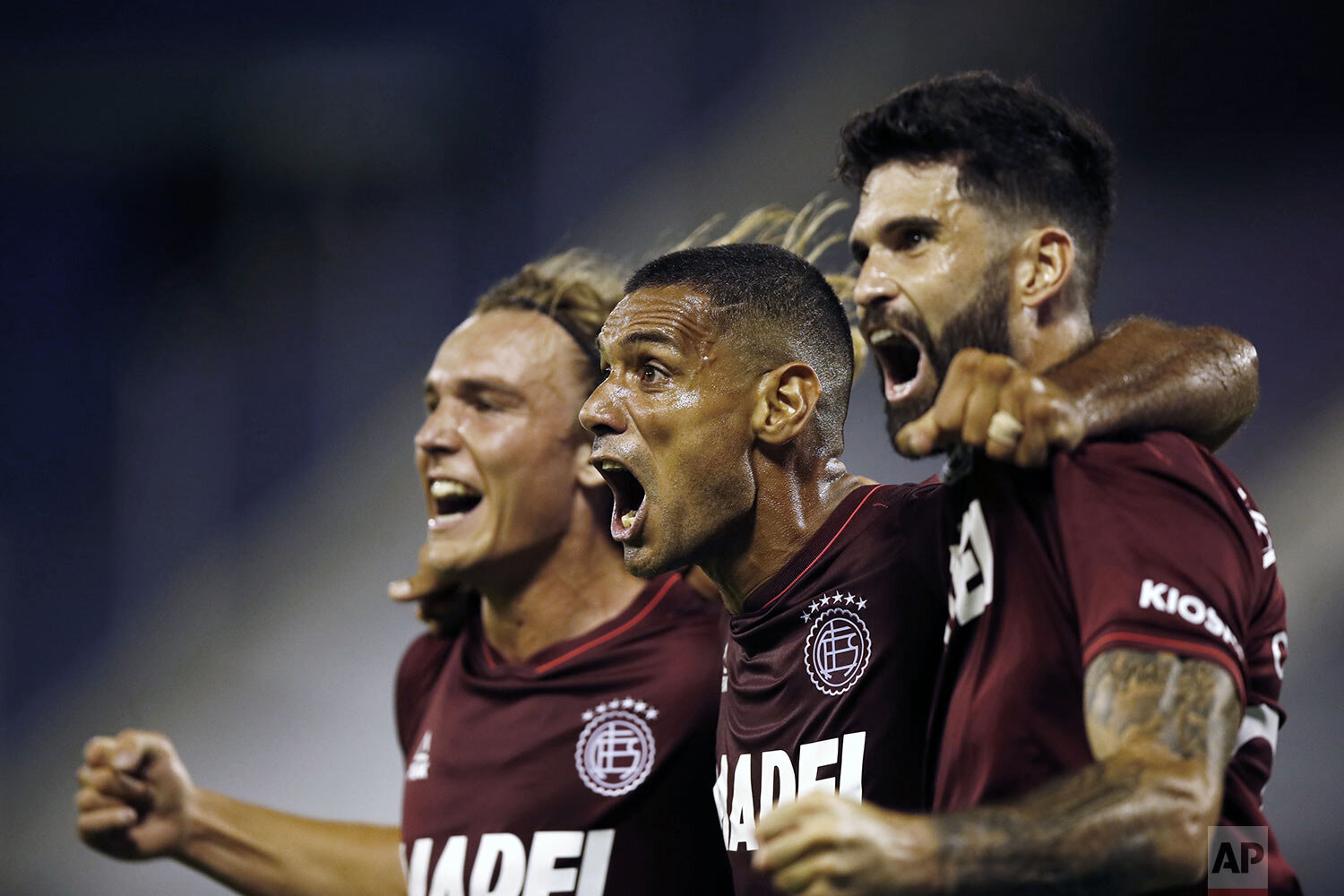 Jose Sand of Argentina's Lanus, center, celebrates with teammates after scoring his side's opening goal against Argentina's Velez Sarsfield at a Copa Sudamericana semifinal first leg soccer match at Jose Amalfitani stadium in Buenos Aires, Argentina