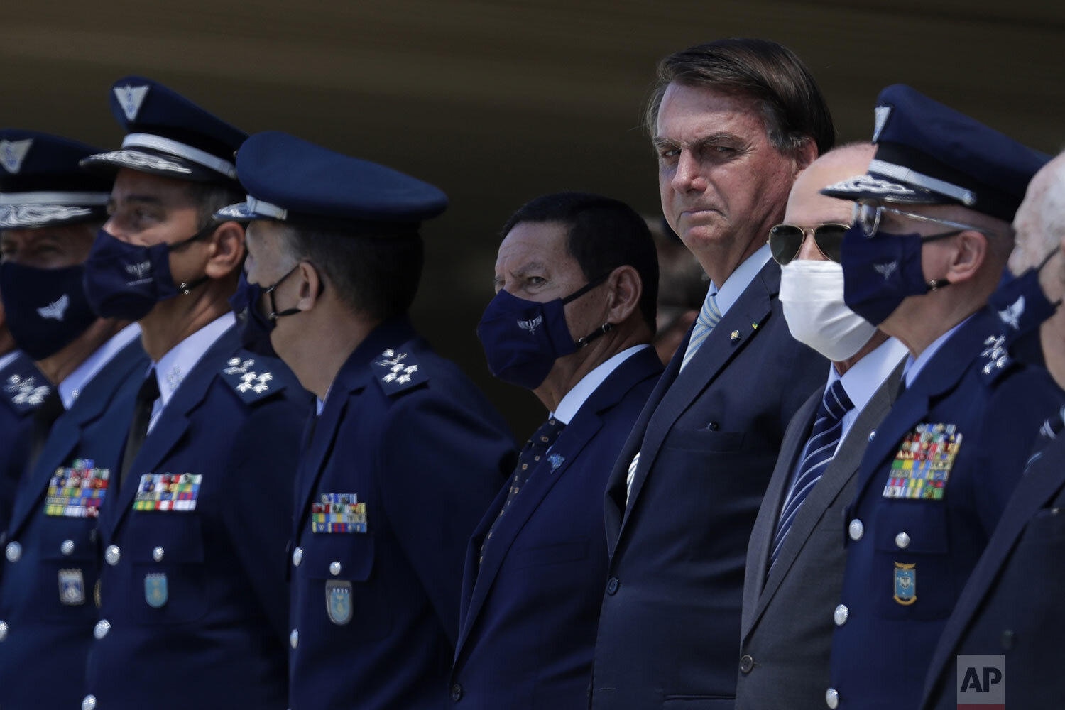  Brazil's President Jair Bolsonaro, fourth from right, flanked by Vice President Hamilton Mourao, left, and Defense Minister Fernando Azevedo, attend a ceremony for the Air Force’s 80th anniversary in Brasilia, Brazil, Jan. 20, 2021. (AP Photo/Eraldo