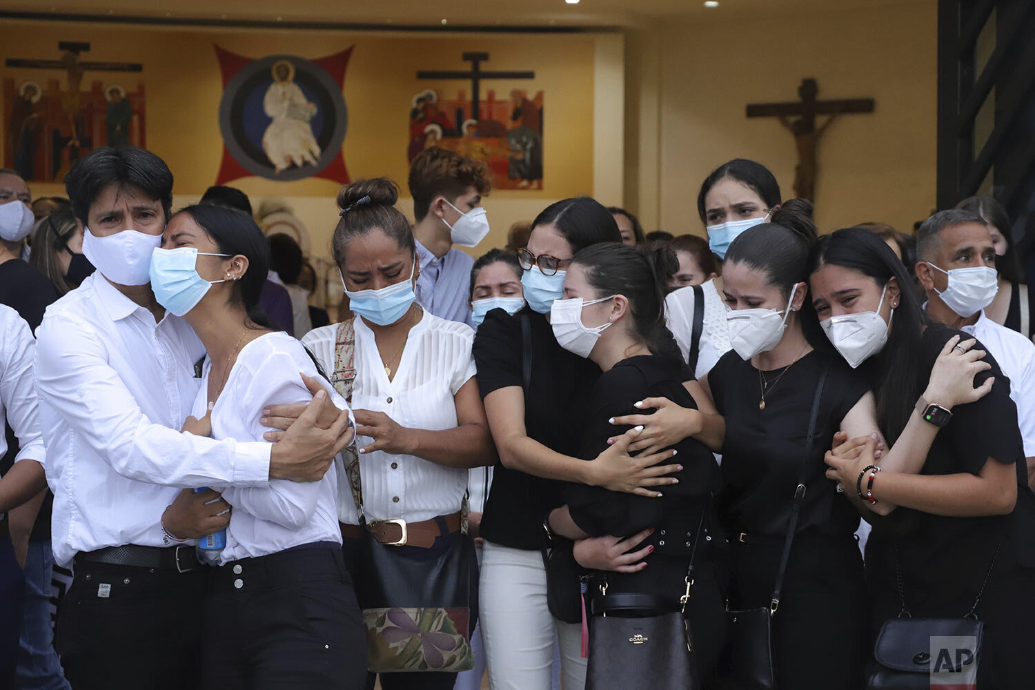  Relatives and friends of Sara Maria Garcia, one of five youths killed by unidentified gunmen two days prior, mourn during her funeral in Buga, Colombia, Jan. 25, 2021. (AP Photo/Juan B. Diaz) 