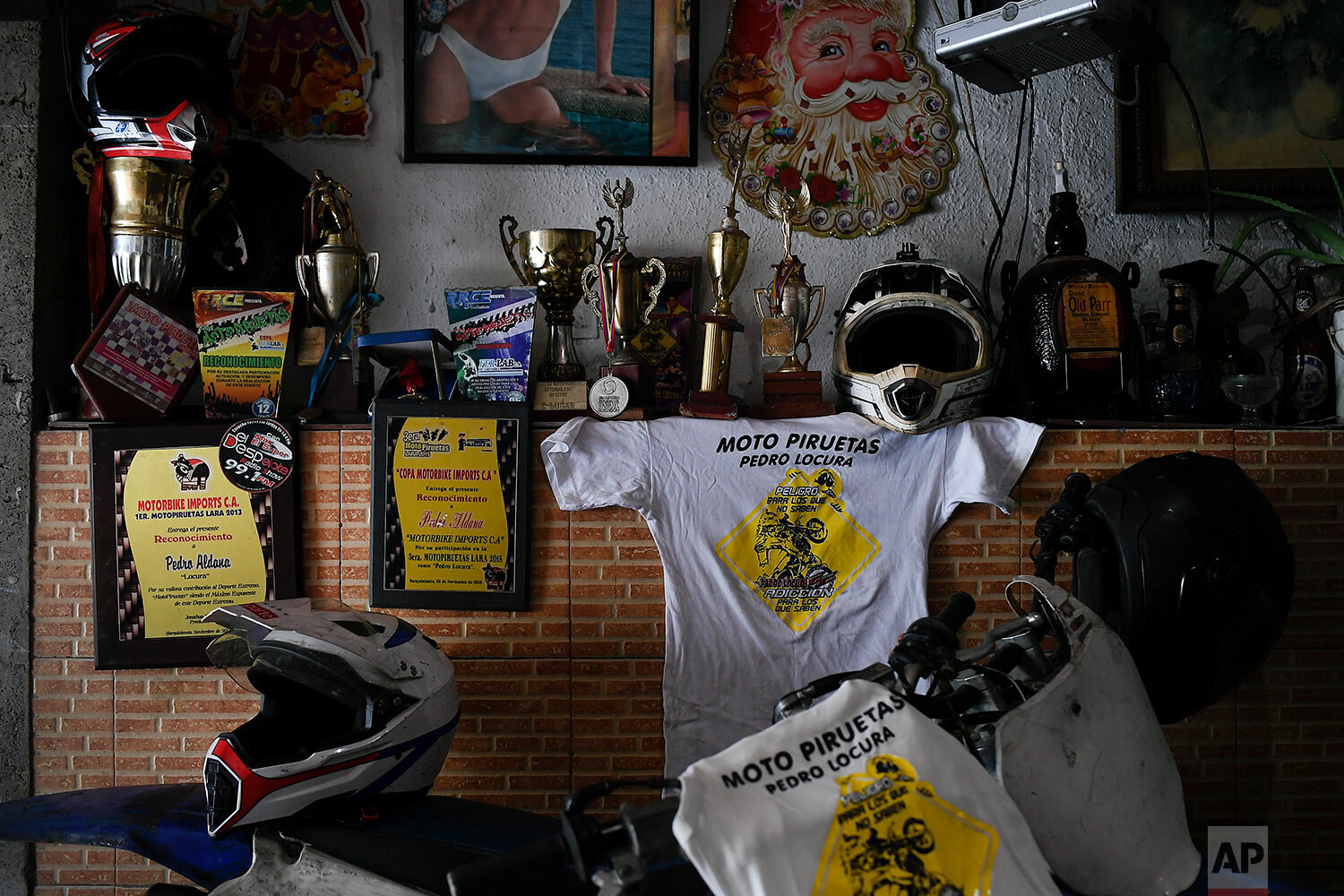  Awards and medals won by motorcycle stuntman Pedro Aldana sit on a wall at his home in the Catia neighborhood of Caracas, Venezuela, Thursday, Jan. 21, 2021. (AP Photo/Matias Delacroix) 