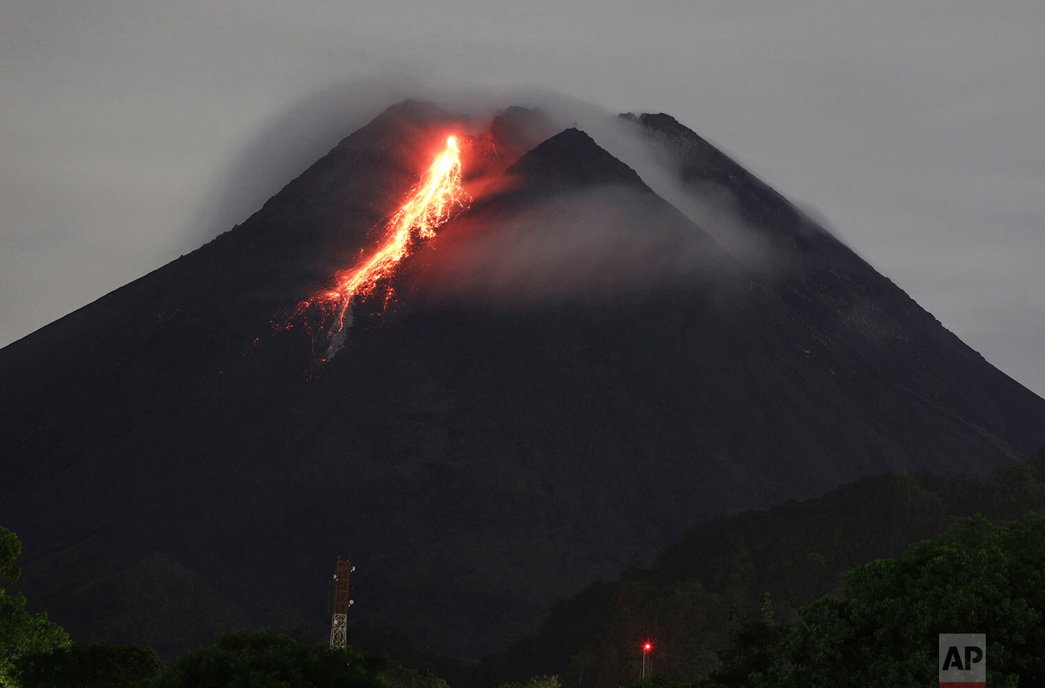  In this photo taken with slow shutter speed, hot lava flows down from the crater of Mount Merapi as its activity continues since local geological authority raised the alert level of the volcano to the second-highest level in November, in Sleman, Ind