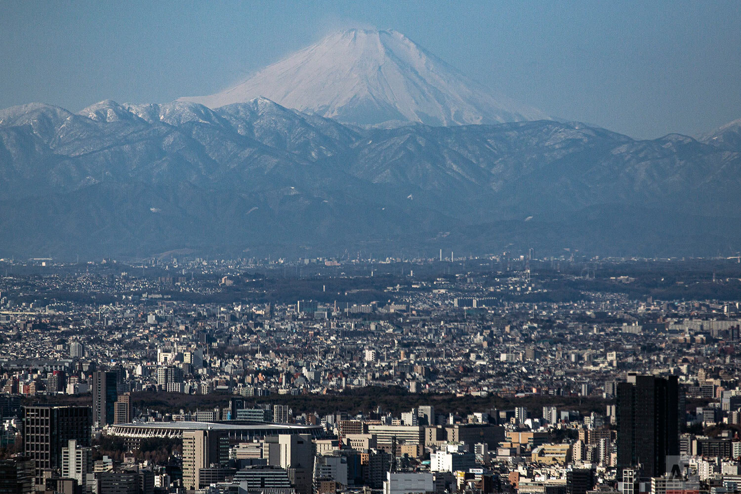 Mount Fuji is viewed clearly through the cool winter air as Japan National Stadium, front left, where an opening ceremony and other events for Tokyo 2020 Olympics are planned, are is seen from an observation deck Friday, Jan. 29, 2021, in Tokyo. (AP