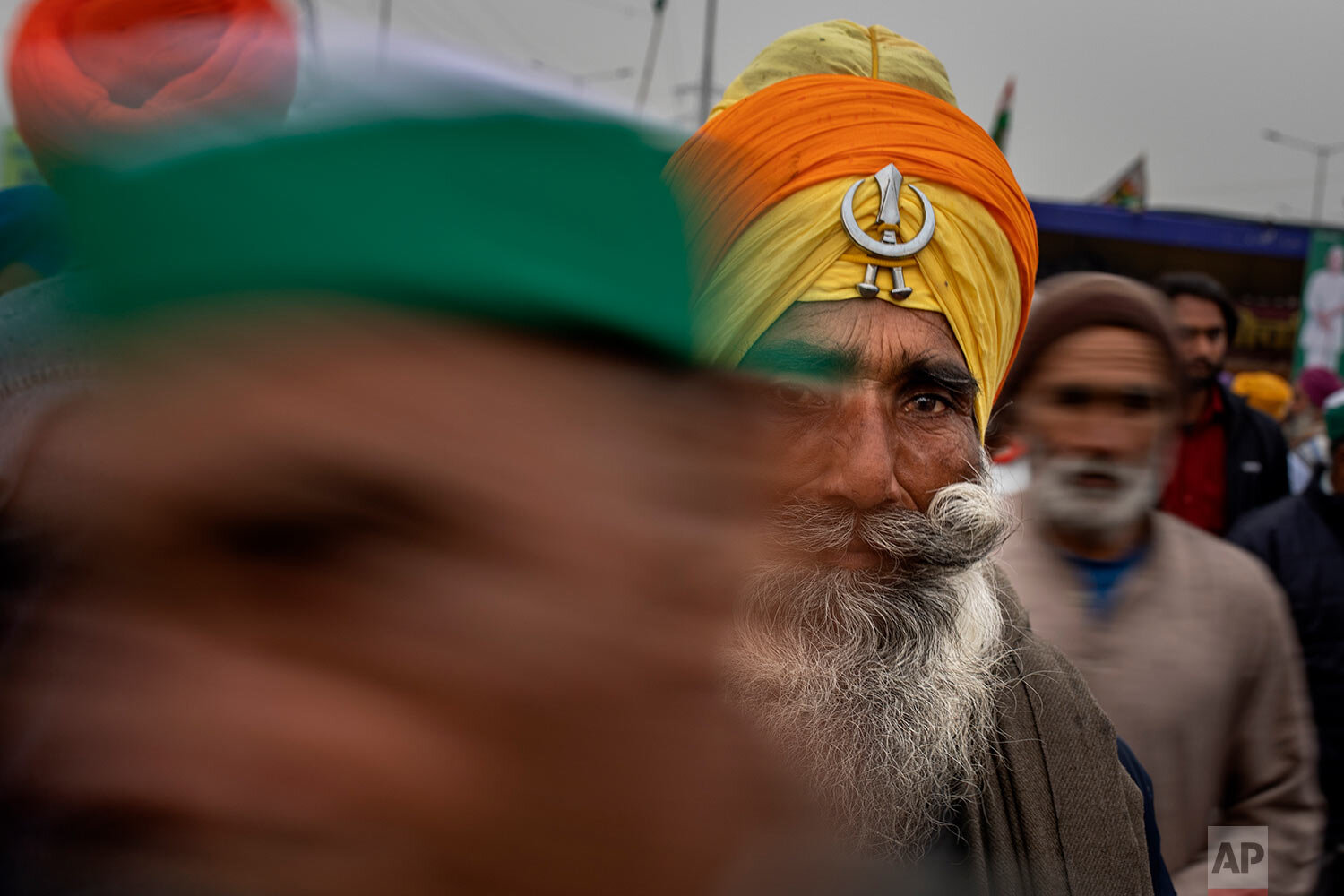  Farmers walk away from the stage as it starts raining during a protest against new farm laws at the Delhi-Uttar Pradesh state border, India, Monday, Jan. 4, 2021. (AP Photo/Altaf Qadri) 