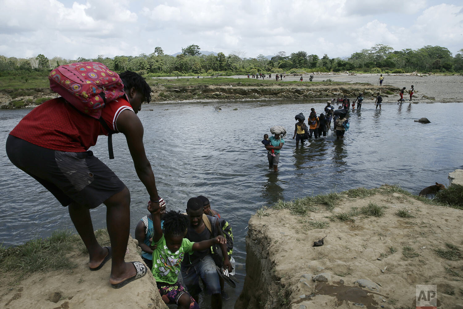  Migrants cross the Tuquesa river after a trip on foot through the jungle to Bajo Chiquito, Darien province, Panama, Feb. 10, 2021. (AP Photo/Arnulfo Franco) 