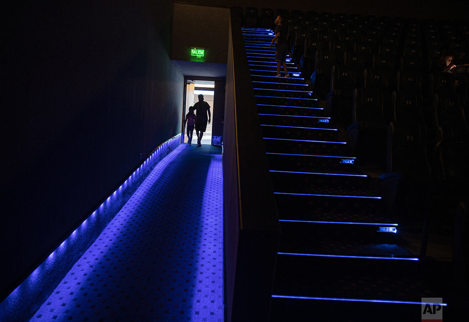  Movie goers enter a Cinepolis cinema on the first day after the COVID-19 lockdown in Santiago, Chile, Feb. 18, 2021. (AP Photo/Esteban Felix) 