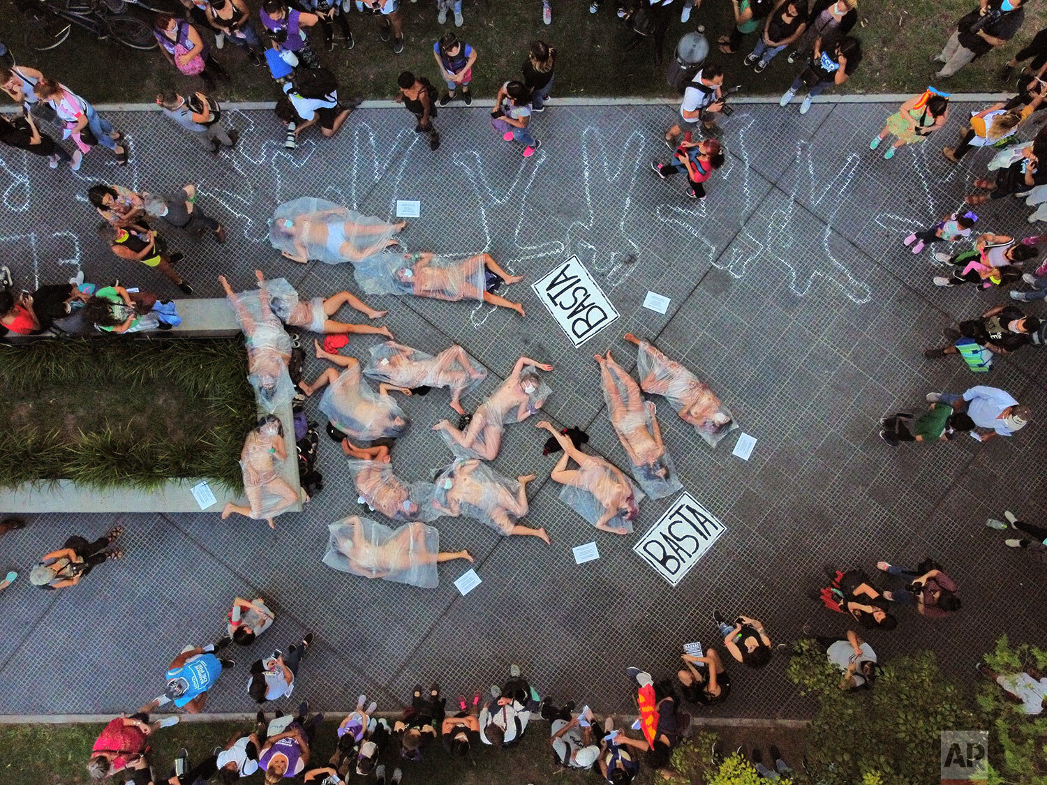  EDS NOTE: NUDITY - Female protesters lie on a sidewalk covered in plastic bags in protest gender violence in Buenos Aires, Argentina, Feb. 17, 2021. Women from the “Ni Una Menos” or “Not One Less” movement protested what they call negligence by judg