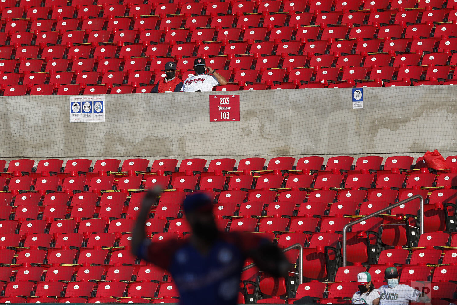  A few fans watch Dominican Republic's starting pitcher Joe Van Meter throw to a Panama batter in the fourth inning of a Caribbean Series baseball game in Mazatlan, Mexico, Feb. 2, 2021. (AP Photo/Moises Castillo) 