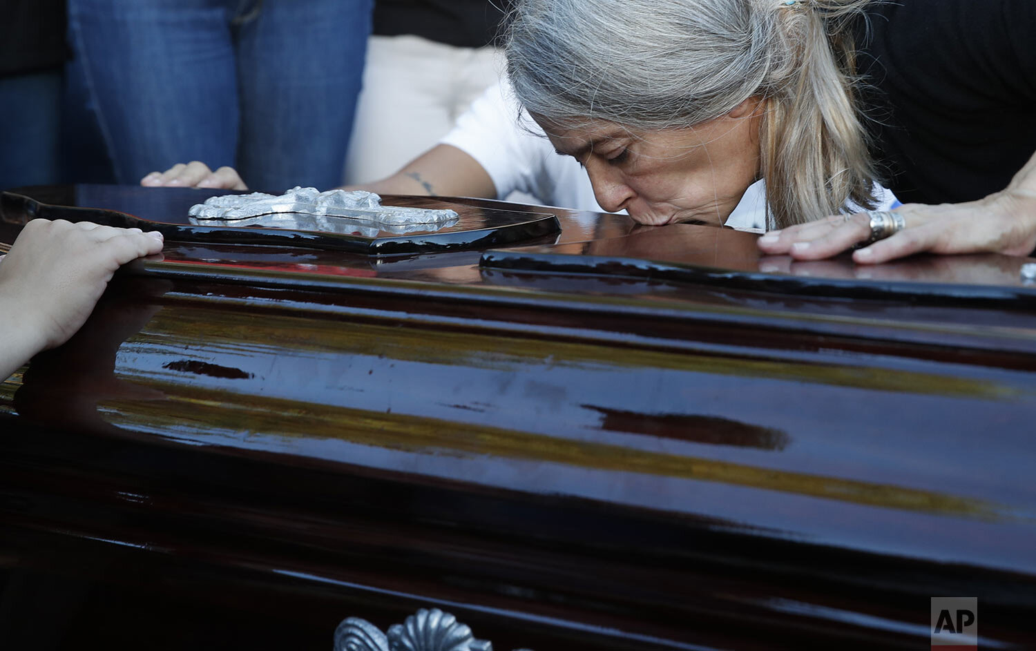  Patricia Nasutti, mother of 18-year-old Ursula Bahillo who was found in a field stabbed to death, kisses her daughter’s coffin before burying her at the cemetery in Rojas, Argentina, Feb. 10, 2021. Bahillo's ex-boyfriend, a police officer, has been 