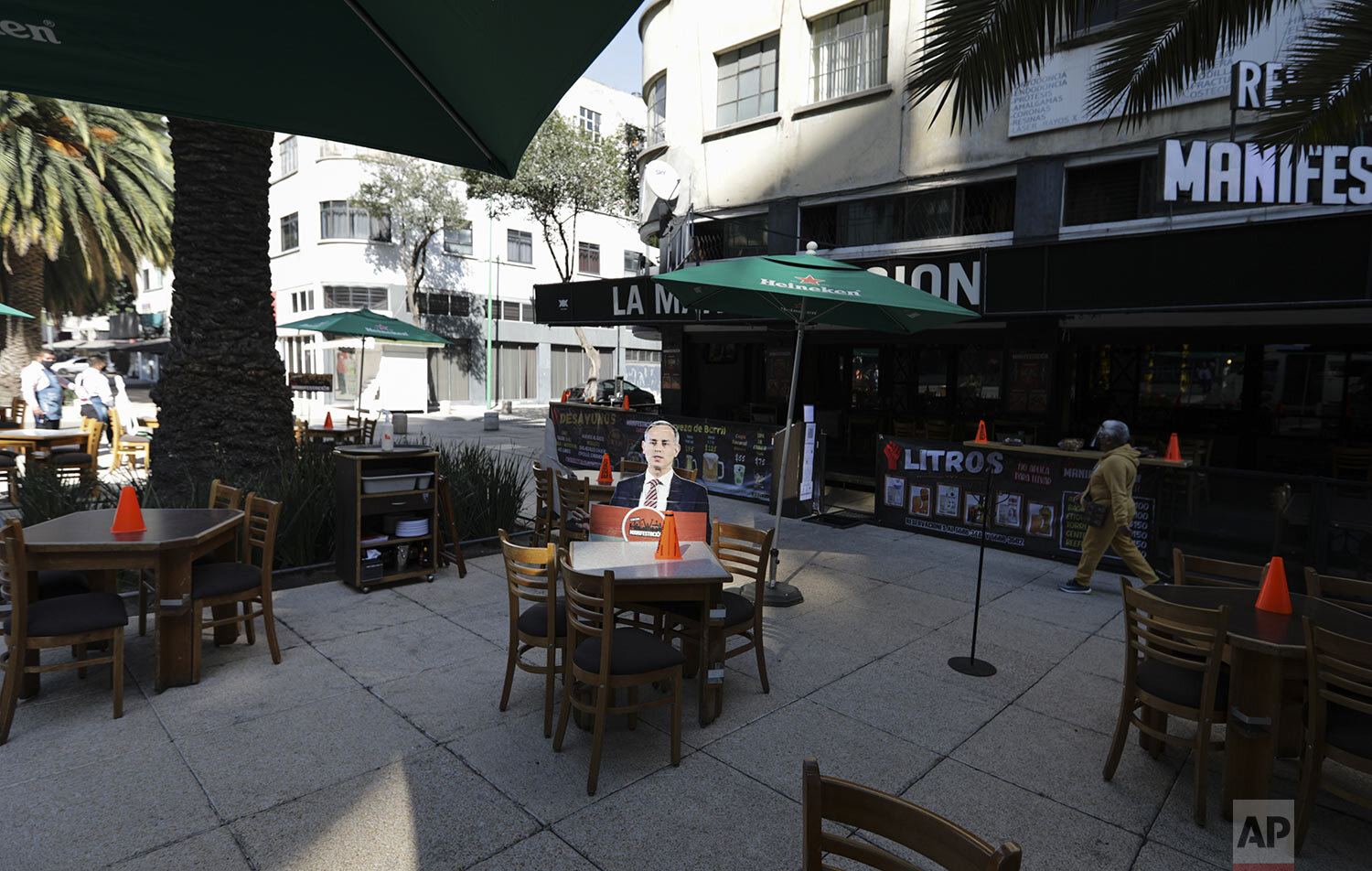  A life-size cutout of Mexican Deputy Health Secretary Hugo Lopez-Gatell is displayed on the patio of an outdoor restaurant in Mexico City, Feb. 4, 2021, as the city eases restrictions amid the COVID-19 "red alert” shutdown, allowing eateries to serv