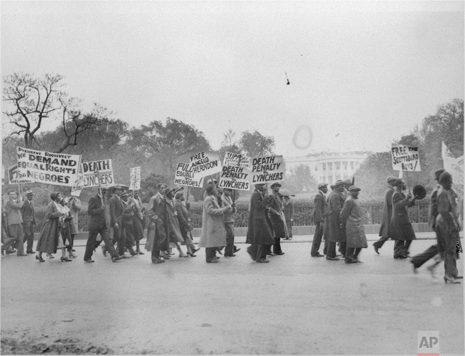  A long line of marchers paraded through the streets of Washington, DC, May 8, 1933, to the White House to present a petition to president Roosevelt asking intervention to free the youths convicted in the Scottsboro, Ala. attack case.  (AP Photo) 