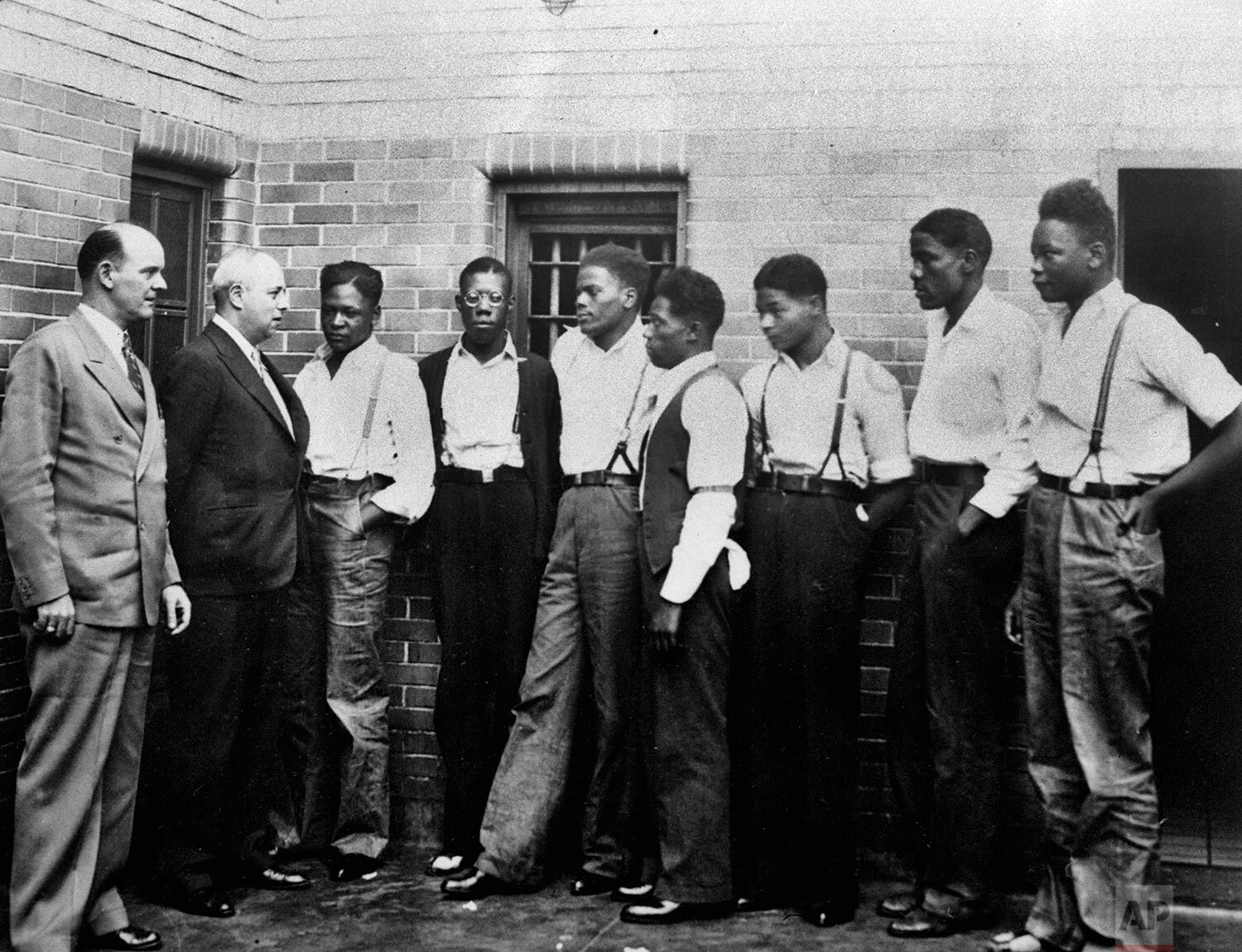  In this May 1, 1935 photo, attorney Samuel Leibowitz from New York, second left, meets with seven of the Scottsboro defendants at the jail in Scottsboro, Ala. just after he asked the governor to pardon the nine youths held in the case. From left are