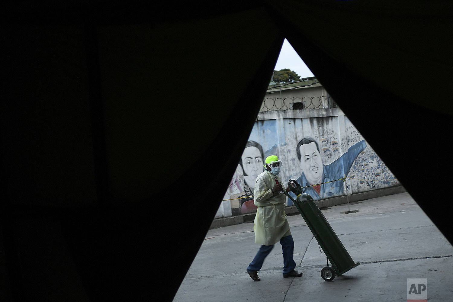 A health worker rolls in an oxygen tank at the Ana Francisca Perez de Leon II public Hospital during the COVID-19 pandemic in Caracas, Venezuela, March 27, 2021. (AP Photo/Matias Delacroix)