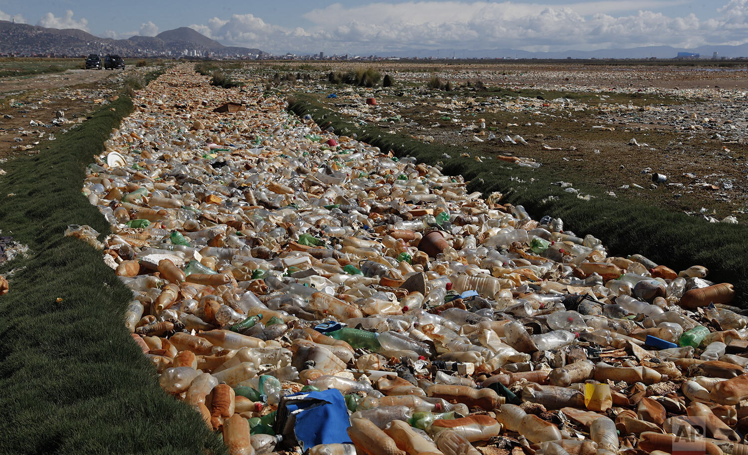Plastic bottles and garbage float on the Tagaret River, which flows into Uru Uru Lake, near Oruro, Bolivia, March 25, 2021. (AP Photo/Juan Karita)