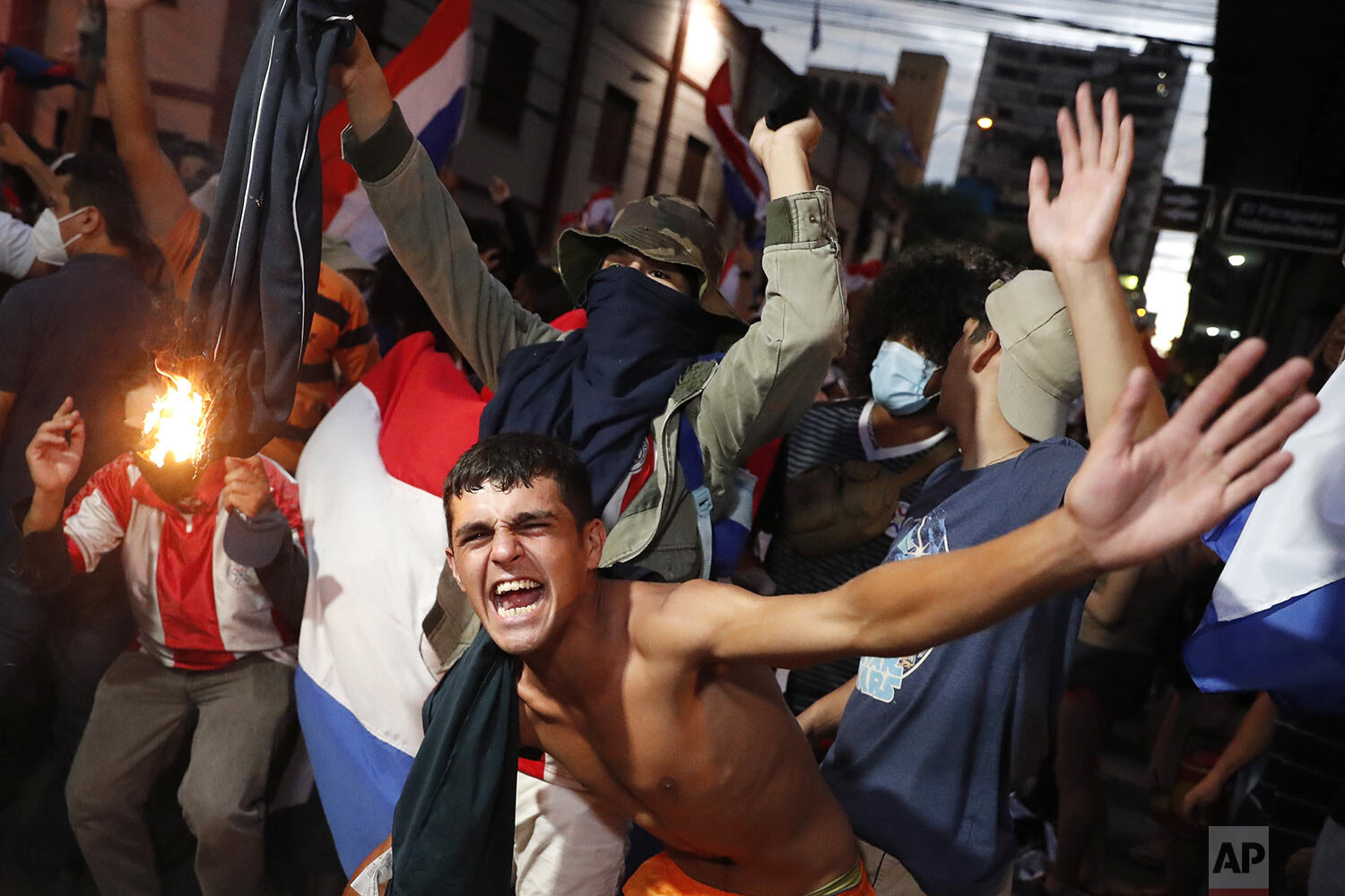Youth protest the shortage of medications for COVID-19 patients in hospitals and the low availability of the vaccine after the resignation of the country’s health minister in Asuncion, Paraguay, March 5, 2021. (AP Photo/Jorge Saenz)