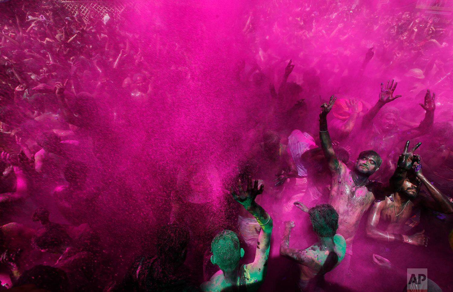  Hindu devotees throw colored powder and dance as they celebrate "Holi," the festival of colors in Prayagraj, India, Tuesday, March 30, 2021. (AP Photo/Rajesh Kumar Singh) 